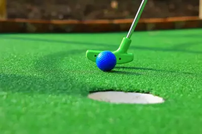 blue golf ball being hit in the hole