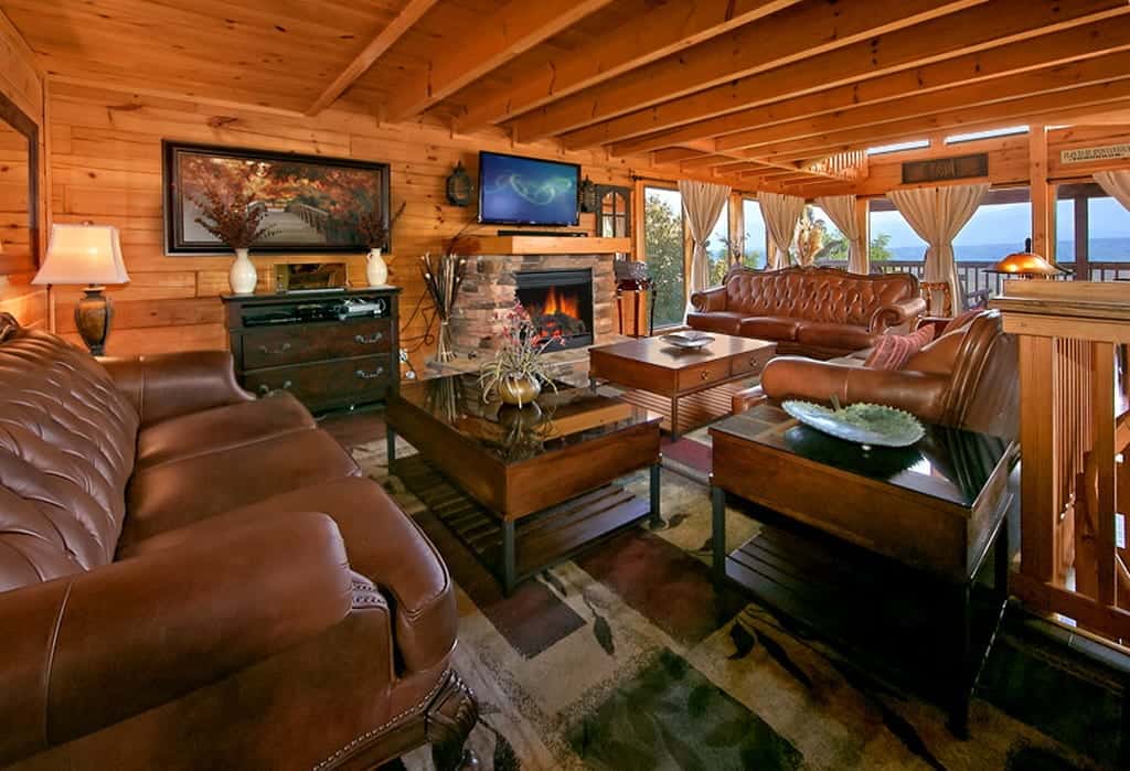 living room in a large cabin with a fireplace and couches