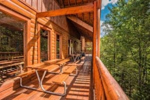 deck on a cabin with picnic tables